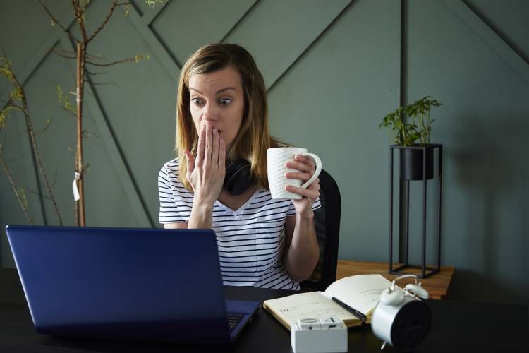 woman on laptop reading negative review of vacation rental property