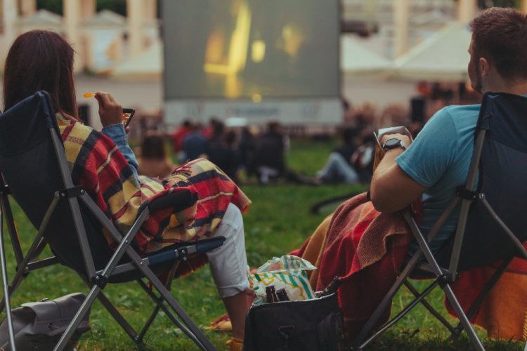 two people watching outdoor movies