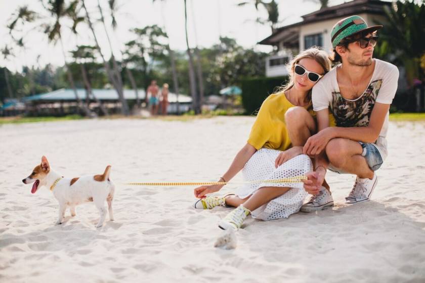 couple with pet dog at beach vacation rental