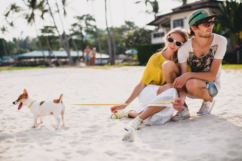 couple with pet dog at beach vacation rental