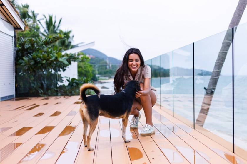 woman with dog on beach vacation rental