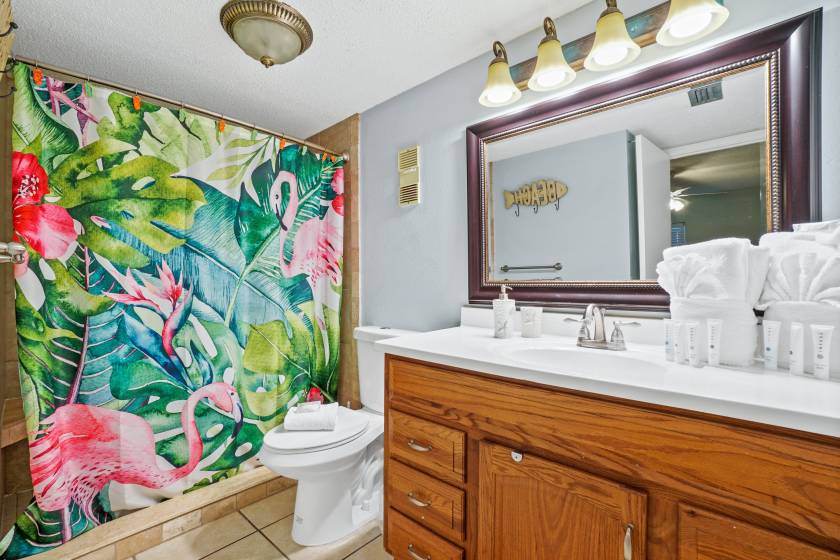 beach condo bathroom with colorful shower curtain