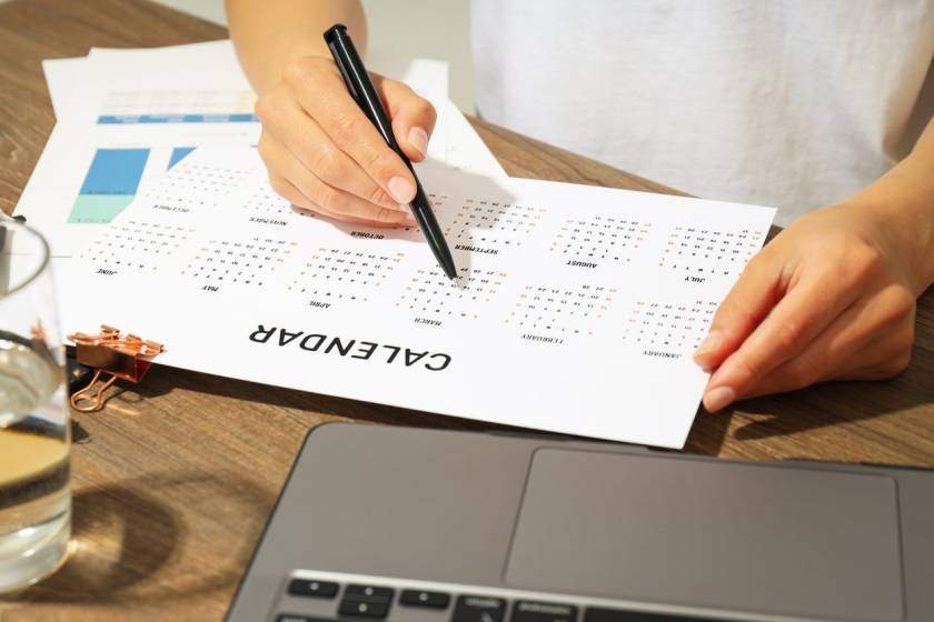 woman with laptop setting calendar for vacation rental property pricing